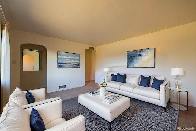 971 Elm Pl, Thornton, CO 80229 - carpeted living area featuring baseboards and arched walkways