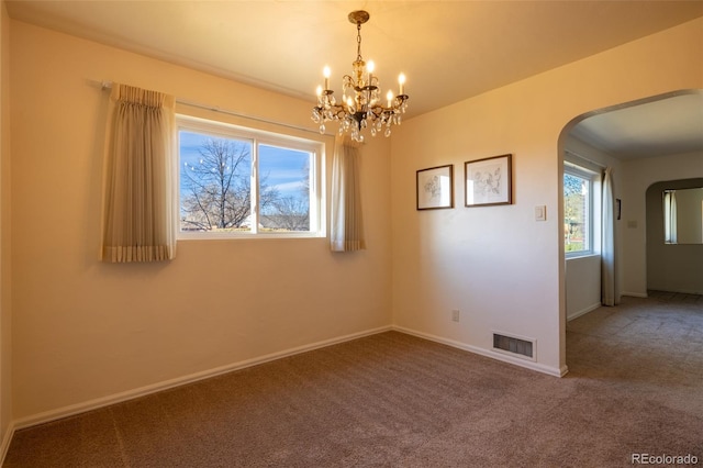 971 Elm Pl, Thornton, CO 80229 - carpeted empty room with arched walkways, a chandelier, and baseboards