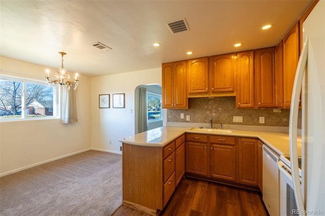 971 Elm Pl, Thornton, CO 80229 - kitchen featuring white appliances, a peninsula, light countertops, healthy amount of natural light, and recessed lighting