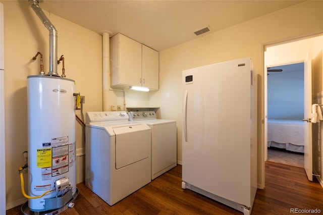 971 Elm Pl, Thornton, CO 80229 - washroom with gas water heater, washing machine and clothes dryer, dark wood-type flooring, and cabinet space