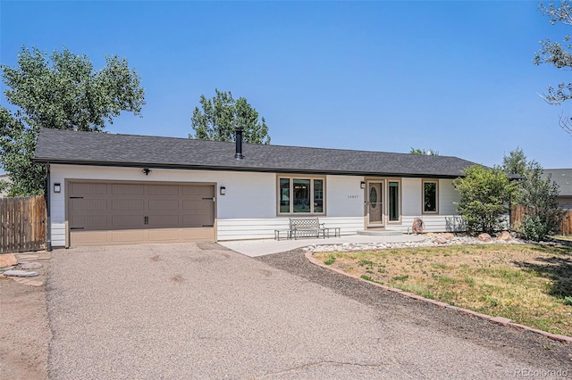 ranch-style house with a garage, covered porch, and a front lawn