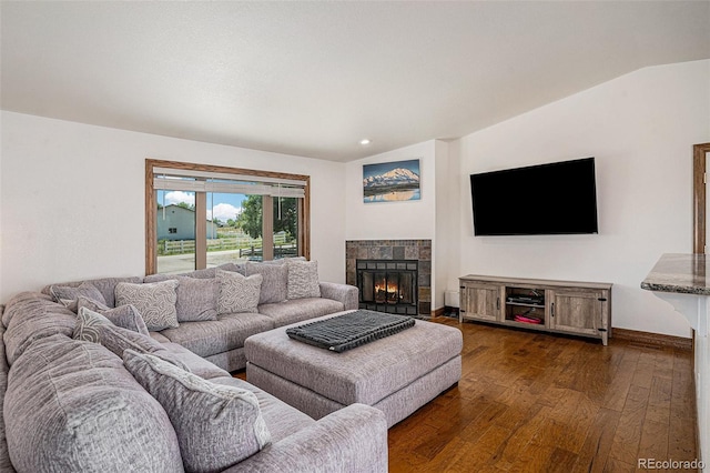 living room featuring a fireplace, lofted ceiling, and dark hardwood / wood-style floors