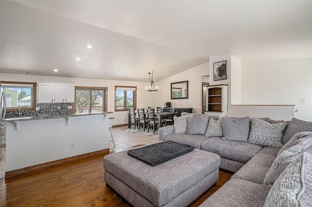 living room with vaulted ceiling and light hardwood / wood-style floors