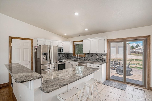 kitchen featuring white cabinets, a healthy amount of sunlight, and appliances with stainless steel finishes