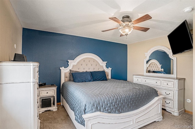 bedroom featuring light colored carpet and ceiling fan