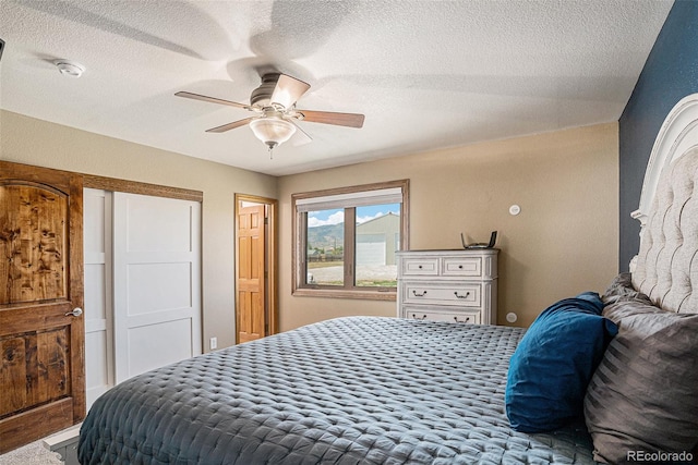 bedroom featuring a textured ceiling and ceiling fan