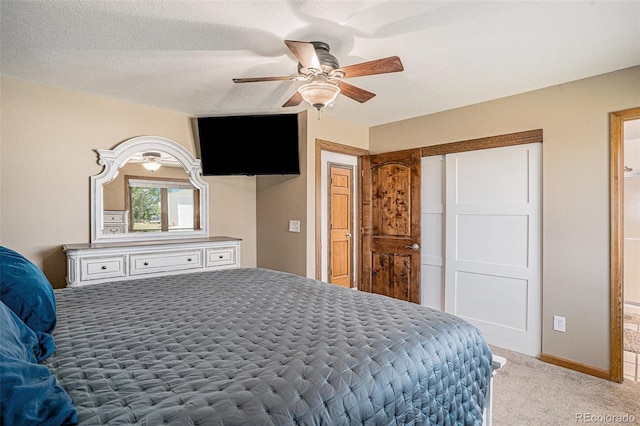 carpeted bedroom featuring a textured ceiling and ceiling fan