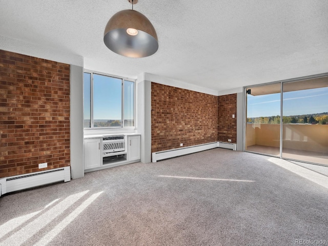 850 20th St Unit 503, Boulder, CO 80302 - unfurnished living room featuring brick wall, a textured ceiling, carpet flooring, a baseboard radiator, and a wall mounted AC