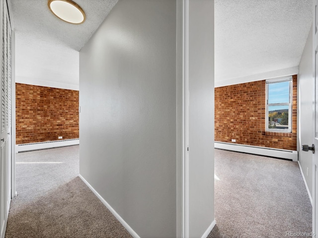850 20th St Unit 503, Boulder, CO 80302 - hallway featuring baseboard heating, carpet flooring, a textured ceiling, baseboards, and brick wall