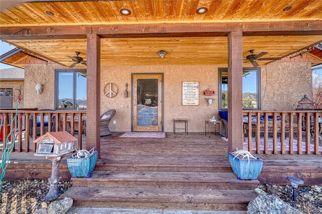 exterior space with ceiling fan and a deck