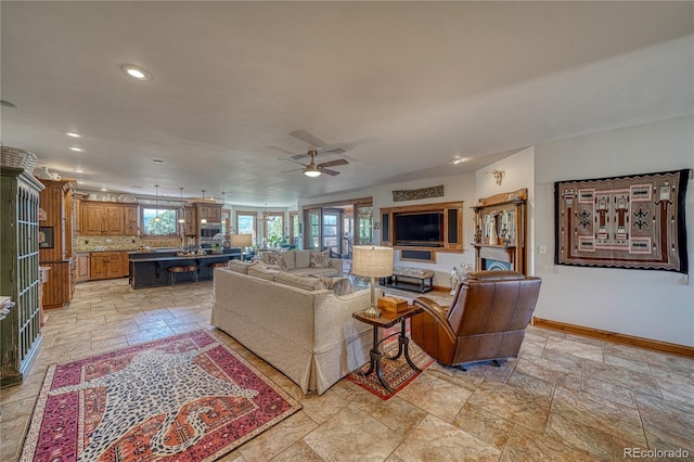 tiled living room featuring ceiling fan