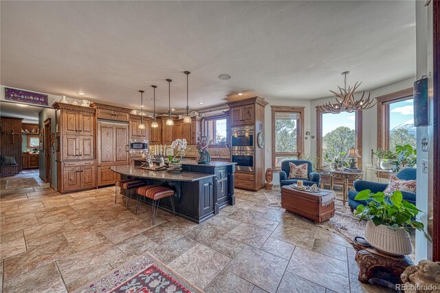 kitchen with stainless steel appliances, tasteful backsplash, a center island, light tile floors, and a breakfast bar