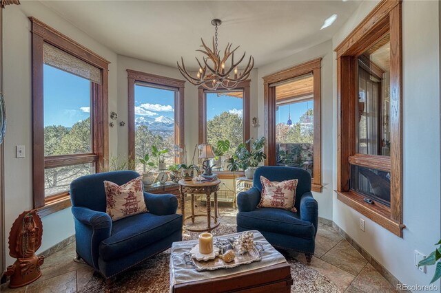 sitting room featuring an inviting chandelier and tile floors