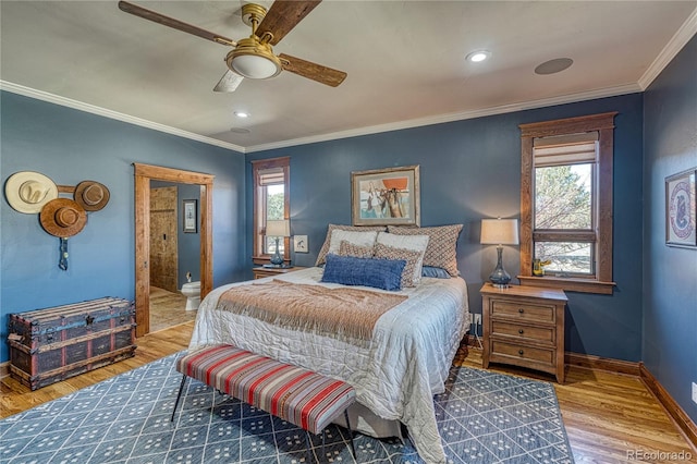 bedroom featuring multiple windows, crown molding, and hardwood / wood-style floors