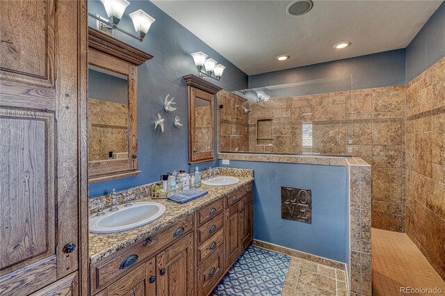 bathroom with tile floors, large vanity, and double sink