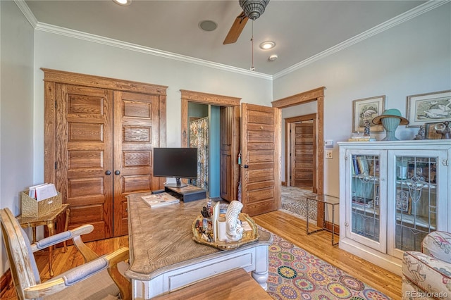 office area featuring crown molding, ceiling fan, and light hardwood / wood-style floors