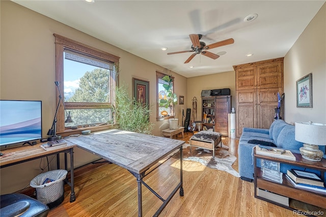 office with ceiling fan and light hardwood / wood-style flooring