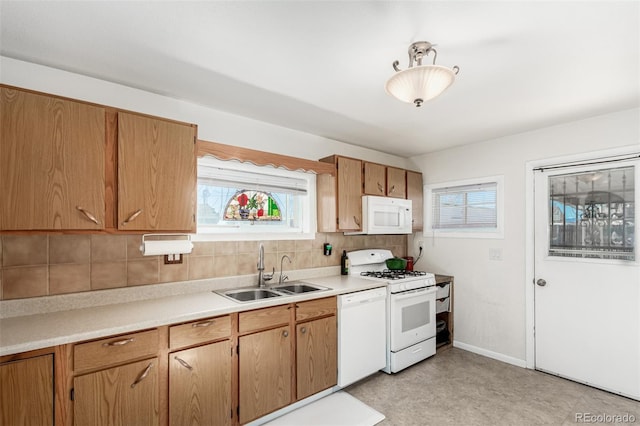 kitchen featuring sink, white appliances, and decorative backsplash