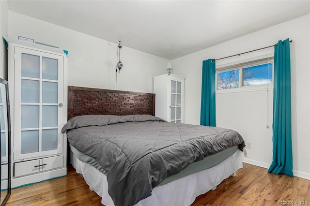 bedroom with hardwood / wood-style flooring