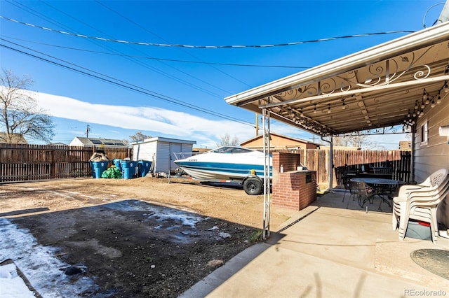 view of patio with a storage shed