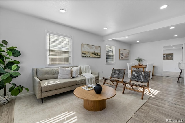 living room featuring light hardwood / wood-style floors and beam ceiling