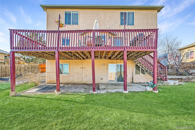 rear view of house featuring a yard, a patio area, and a wooden deck