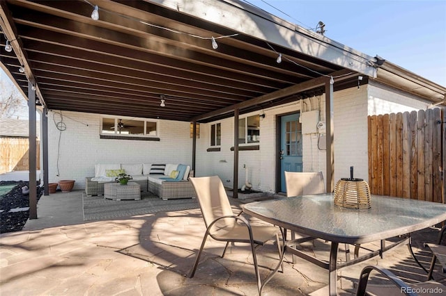 view of patio / terrace with outdoor dining area, outdoor lounge area, and fence