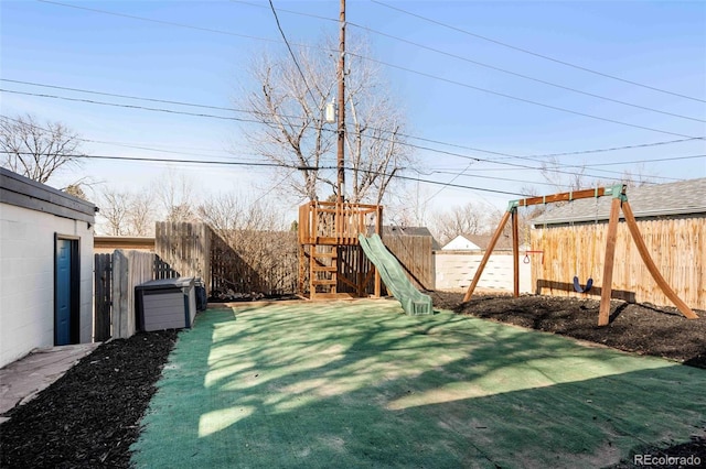 view of yard featuring a playground and a fenced backyard