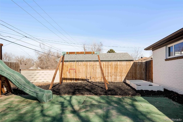 view of yard featuring a playground and a fenced backyard