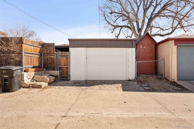 garage featuring fence and a gate