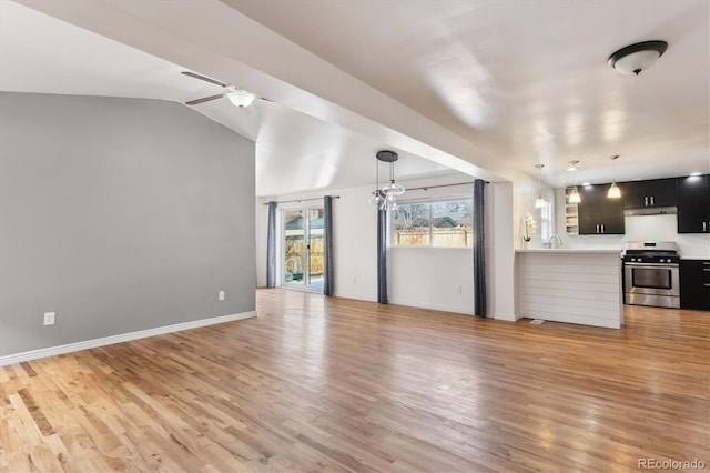 unfurnished living room with ceiling fan, wood-type flooring, sink, and lofted ceiling