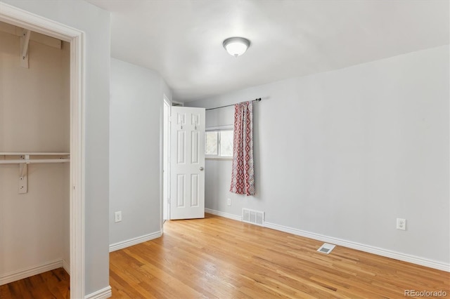 unfurnished bedroom with light wood-type flooring