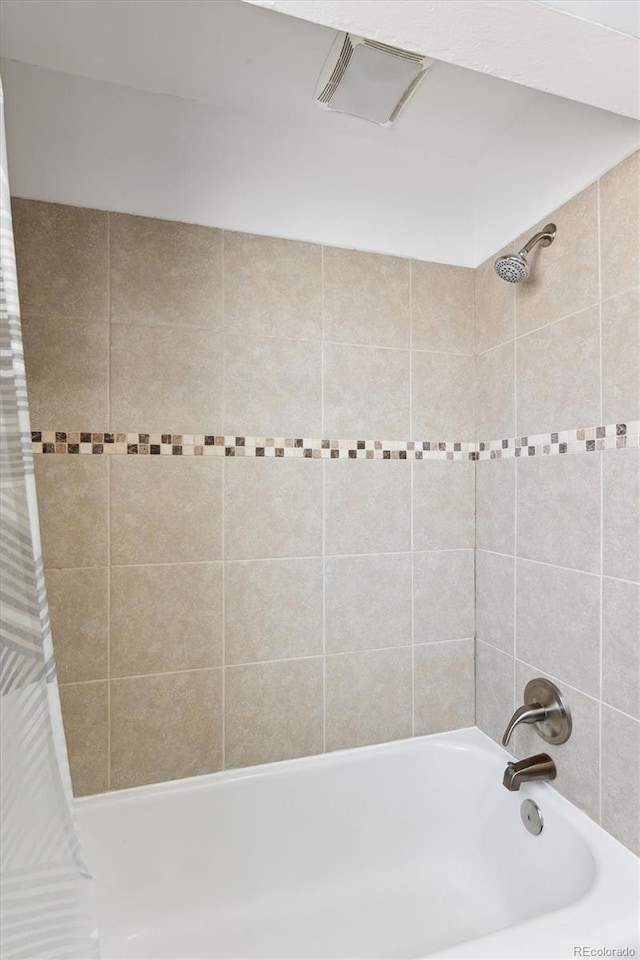 bathroom featuring shower / bath combo with shower curtain