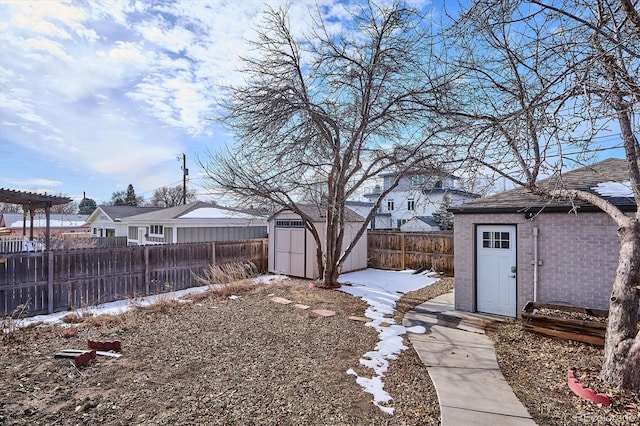 snowy yard with a storage unit