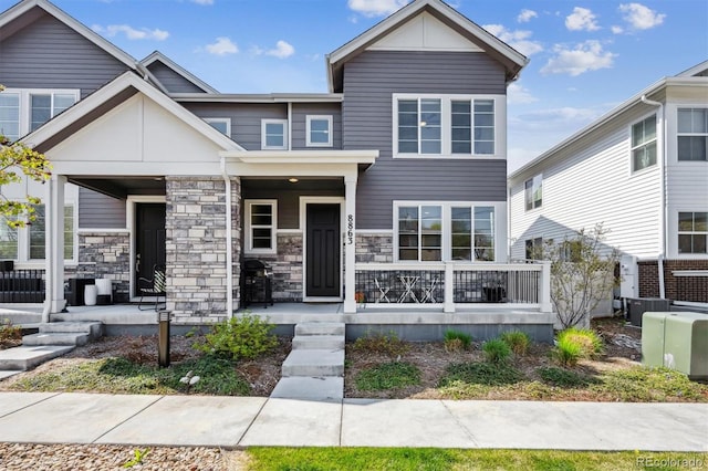view of front of house featuring covered porch and stone siding