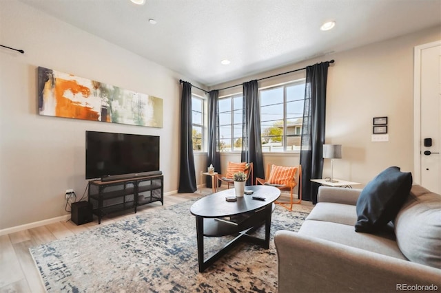 living room featuring wood finished floors, baseboards, and recessed lighting