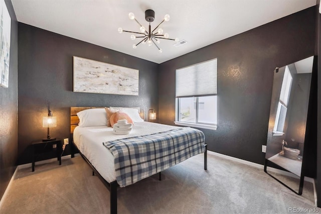 bedroom with a chandelier, carpet, baseboards, and a textured wall