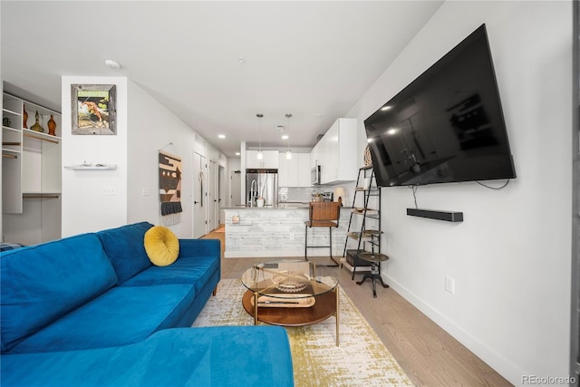 1898 S Bannock St Unit 202, Denver, CO 80223 - living room featuring light wood-style floors, baseboards, and recessed lighting
