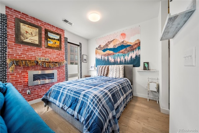 1898 S Bannock St Unit 202, Denver, CO 80223 - bedroom featuring wood finished floors, baseboards, and a fireplace
