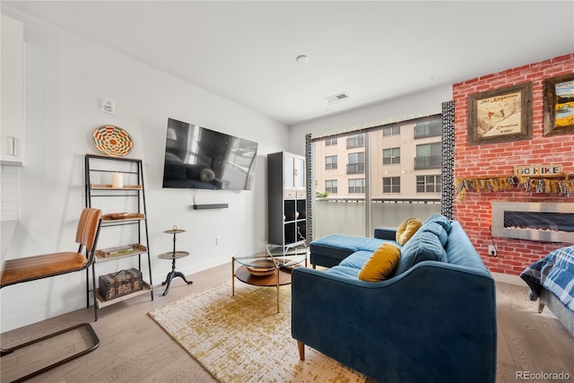 1898 S Bannock St Unit 202, Denver, CO 80223 - living area featuring a fireplace, wood finished floors, and baseboards