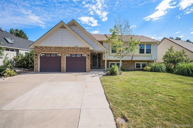 11797 W Aqueduct Dr, Littleton, CO 80127 - view of front of home featuring concrete driveway, a garage, a front yard, and brick siding