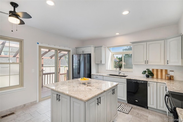 11797 W Aqueduct Dr, Littleton, CO 80127 - kitchen featuring black appliances, a kitchen island, plenty of natural light, ceiling fan, and recessed lighting