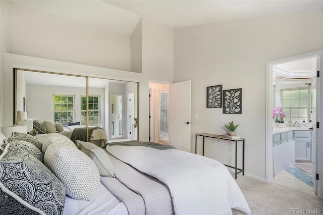 11797 W Aqueduct Dr, Littleton, CO 80127 - bedroom featuring light colored carpet, a closet, and connected bathroom