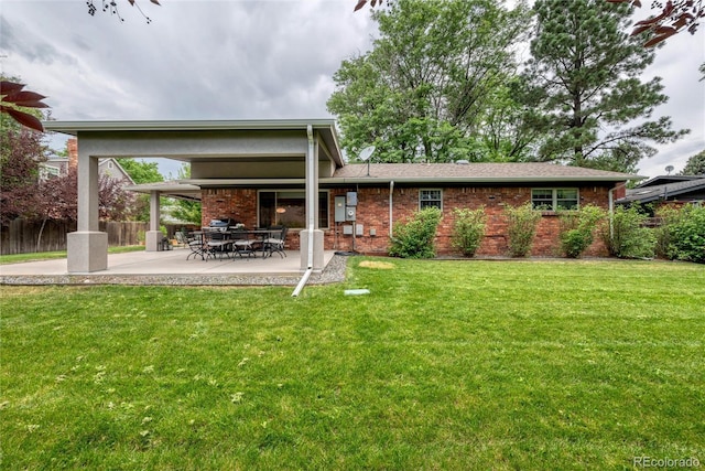 3196 S Newport St, Denver, CO 80224 - rear view of house featuring brick siding and a patio
