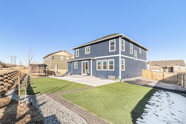 rear view of house featuring a yard, a patio, a trampoline, and cooling unit