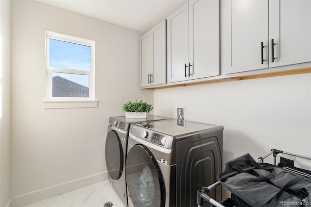 laundry room with cabinets and washing machine and clothes dryer