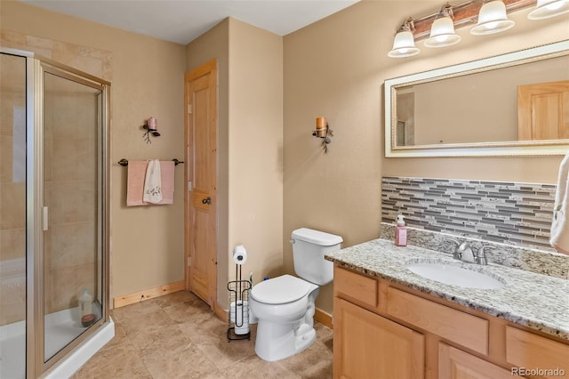 full bathroom featuring vanity, toilet, baseboards, and a stall shower