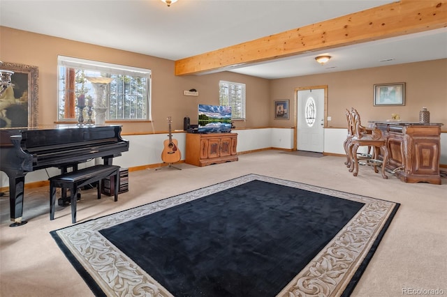 carpeted living room featuring a wealth of natural light, baseboards, and beamed ceiling