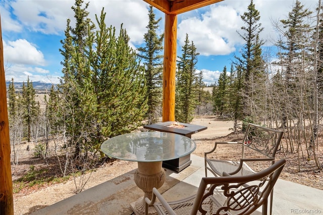 view of patio / terrace featuring an outdoor fire pit and a mountain view