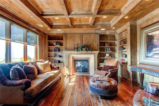 sitting room featuring coffered ceiling, built in shelves, ornamental molding, and dark wood-type flooring